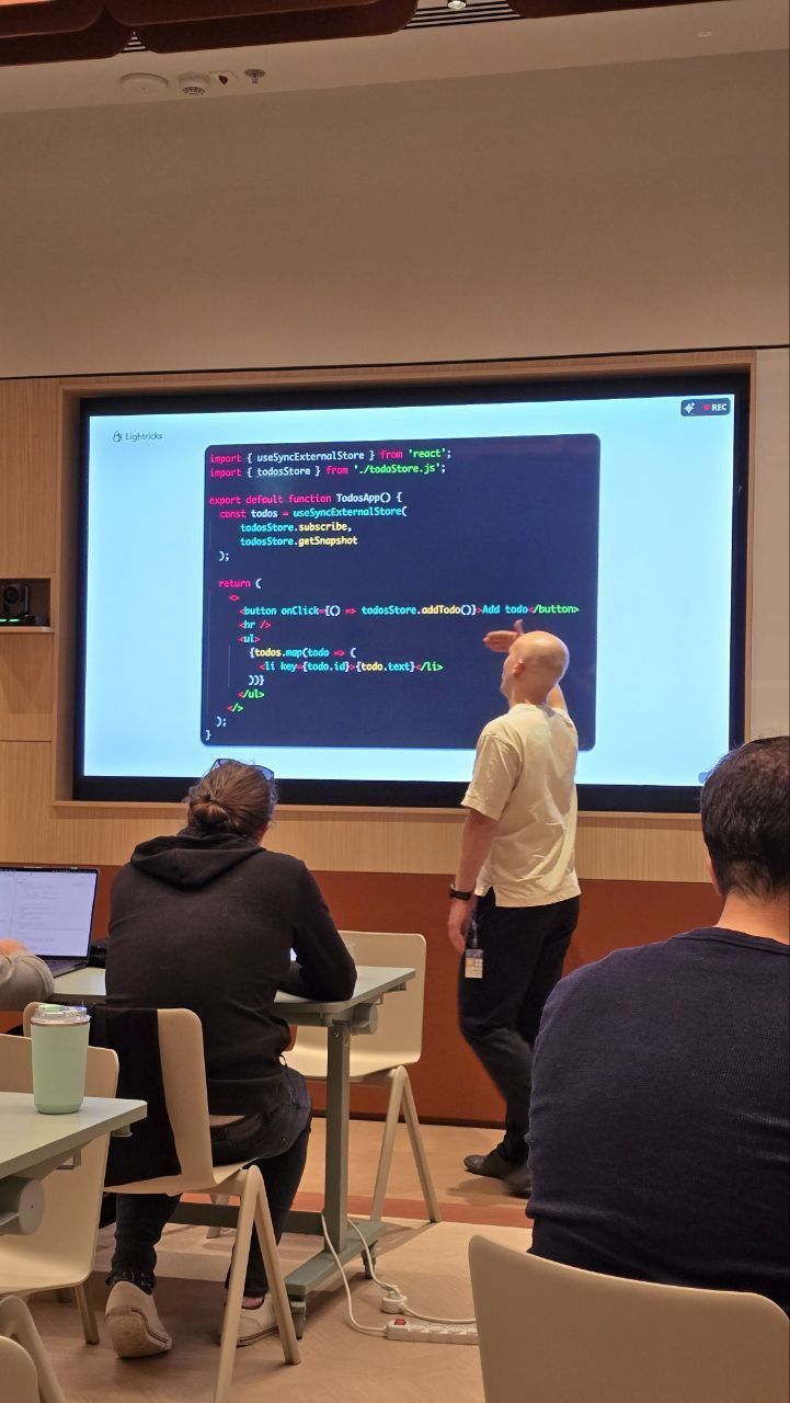 Me at the screen walking the group through useSyncExternalStore, the hook visible in the code behind me.